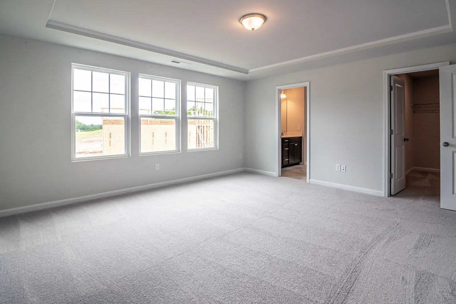 New gray carpet in a bright Crofton, Maryland bedroom