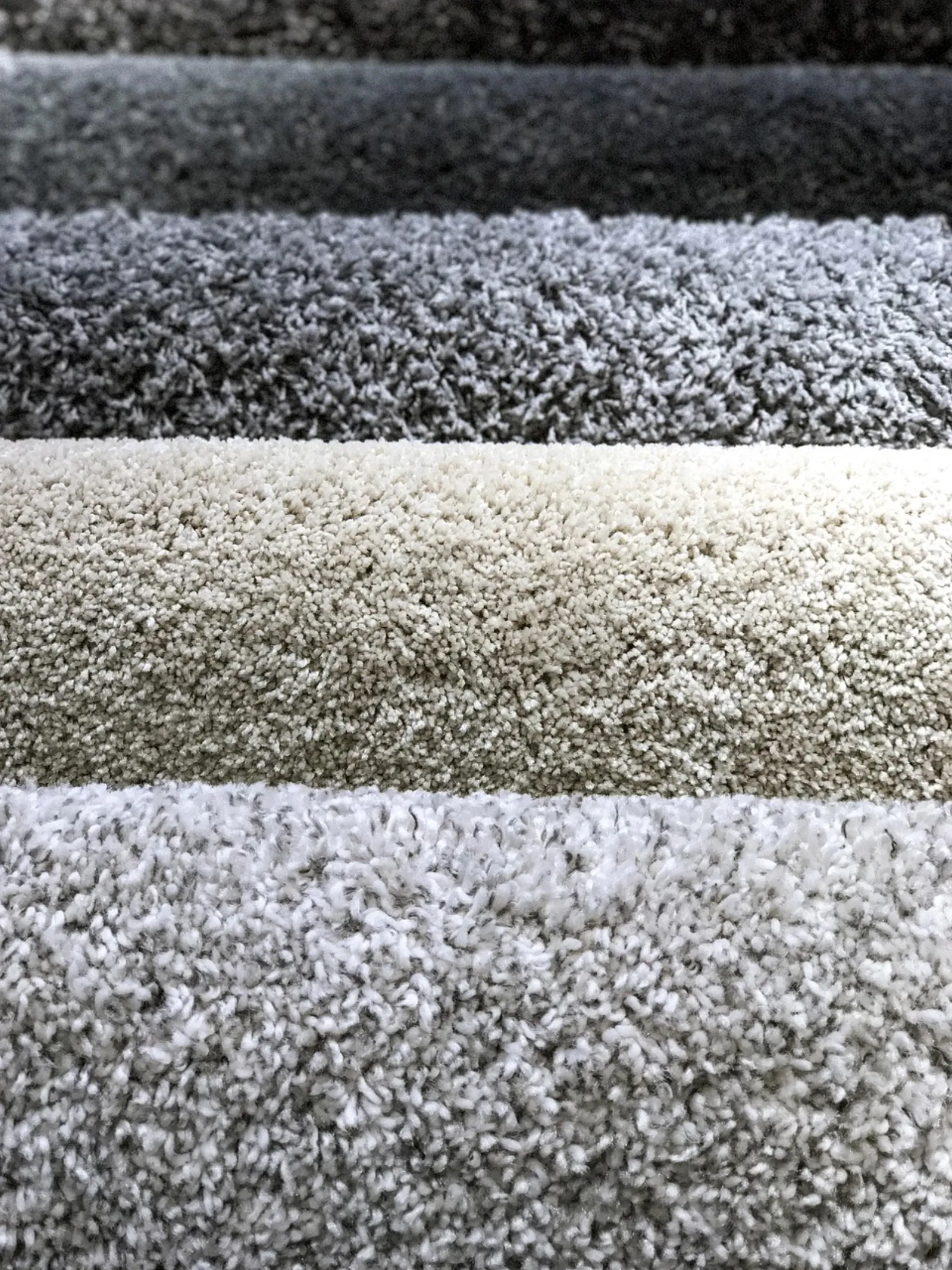 Plush carpet samples in gray, beige and white textures