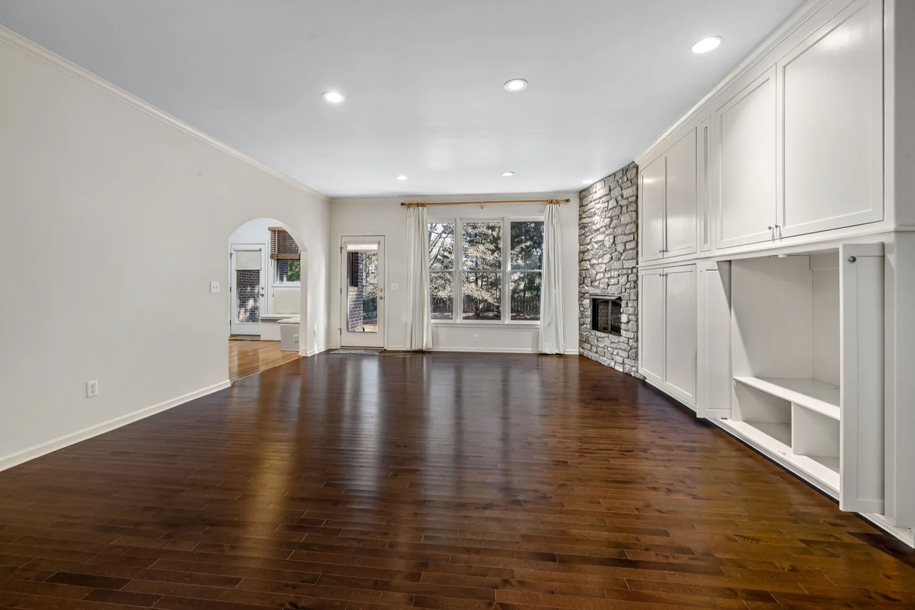 Espresso-stained solid hardwood in a bright living room