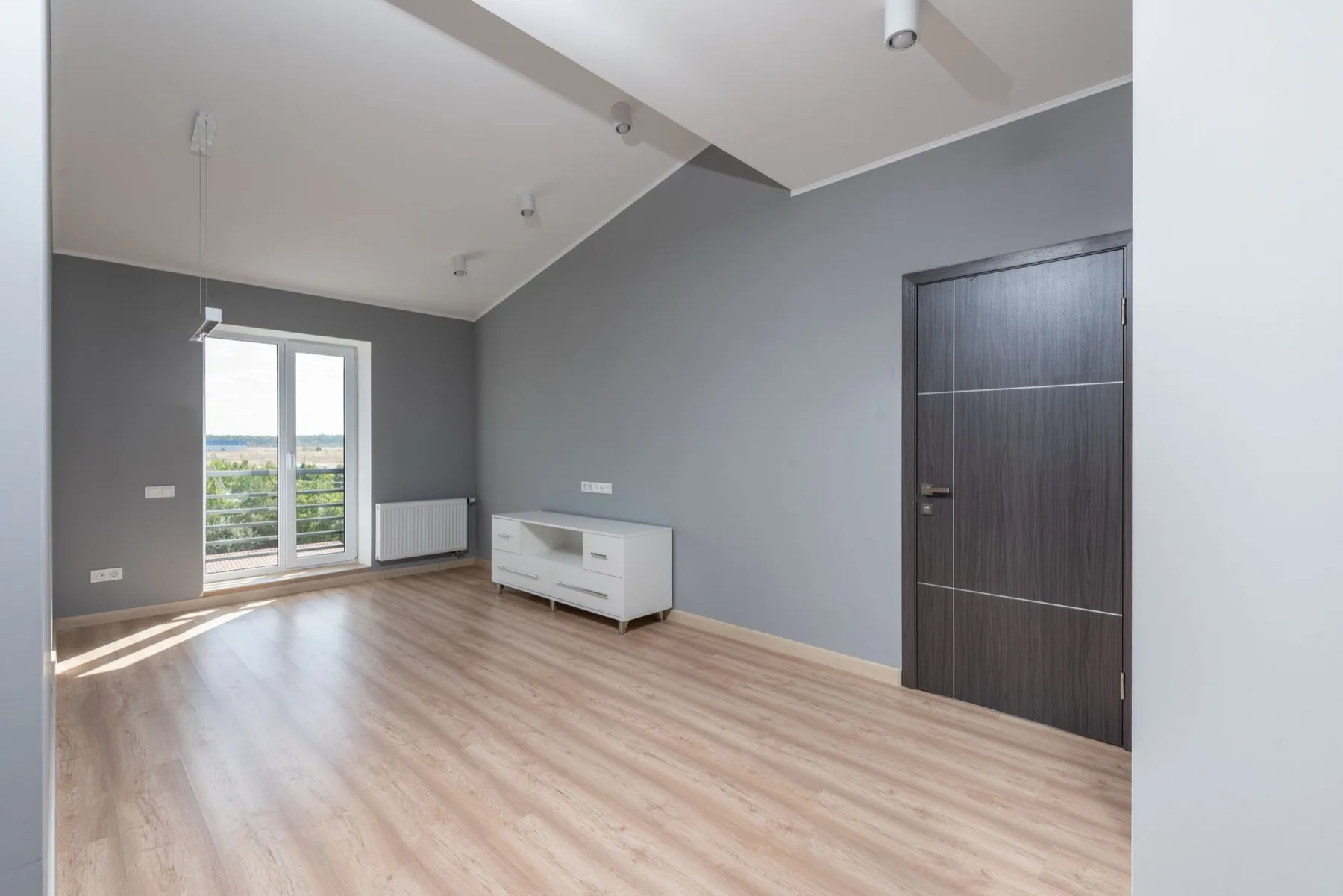 Wide-plank engineered wood flooring in a bright modern DMV bedroom