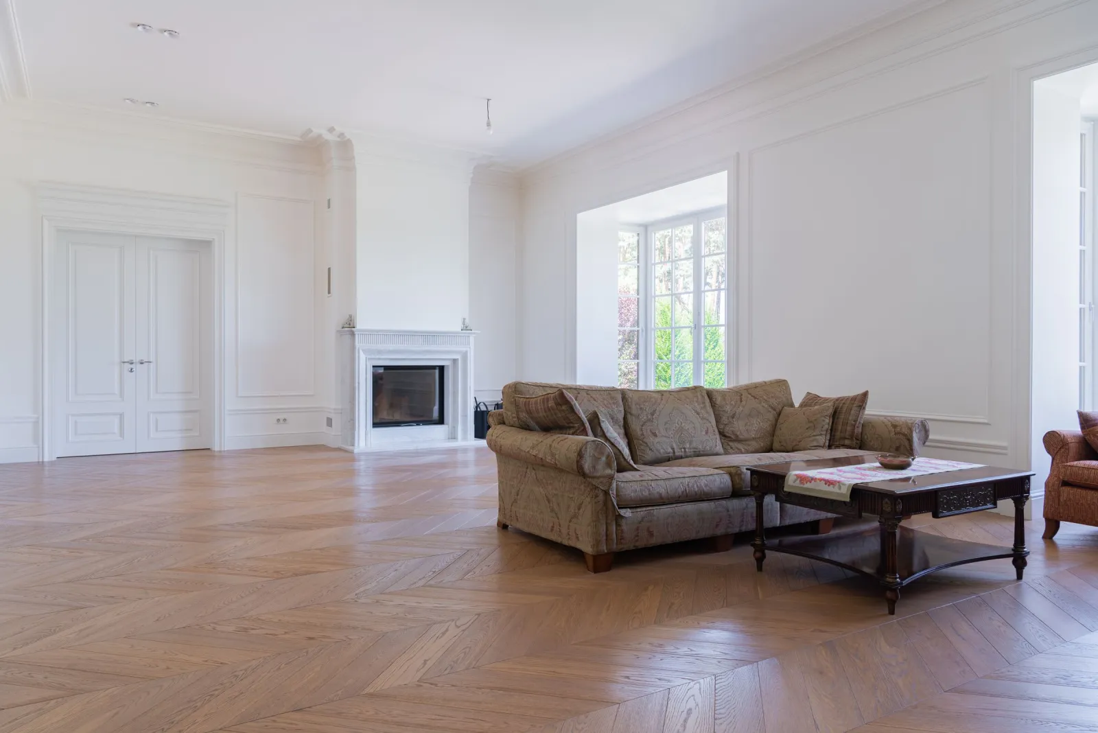 Solid hardwood flooring across an elegant, spacious living room