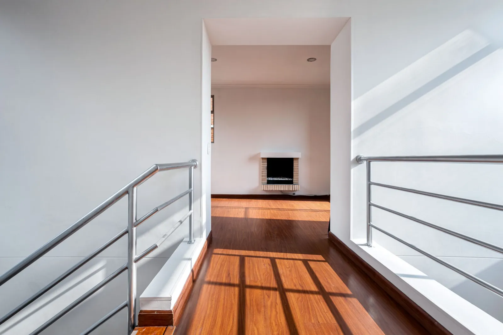 Laminate flooring running down a bright minimalist hallway — Fairland, MD area