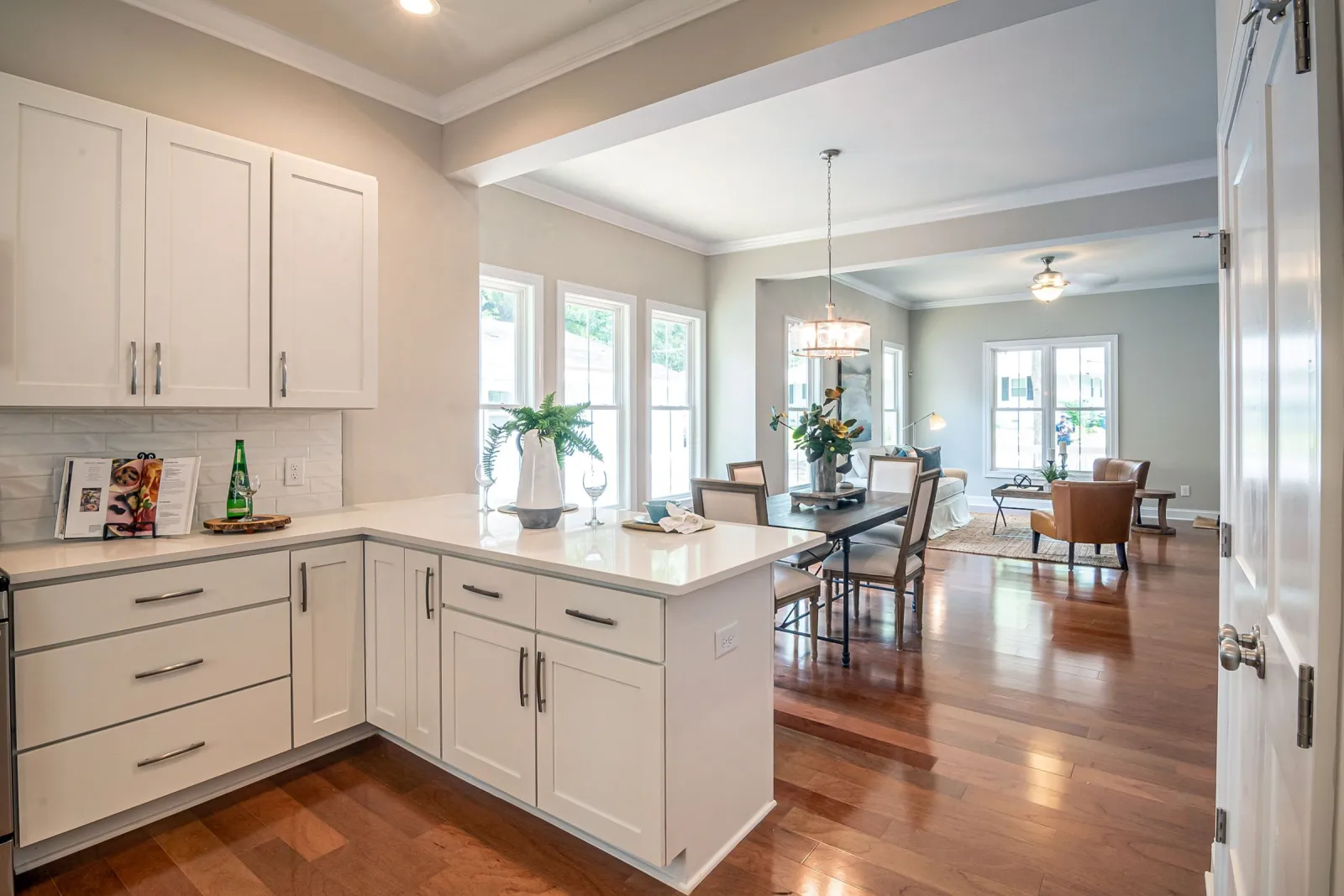 Engineered hardwood through an open-concept kitchen and living space